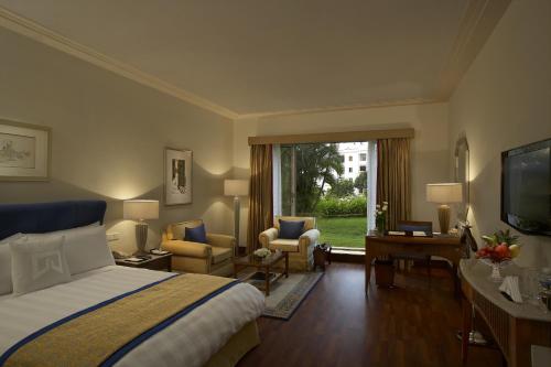 a hotel room with a bed and a television at ITC Kakatiya, a Luxury Collection Hotel, Hyderabad in Hyderabad