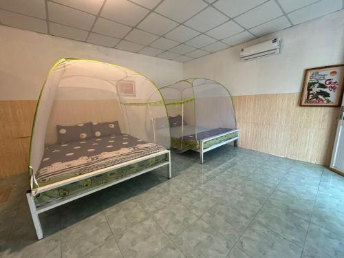 two beds in a room with two glass domes at Mekong Delta Homestay Family Tiny Garden in Bến Lức