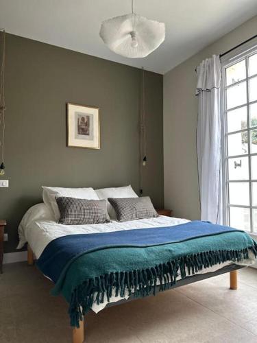 - une chambre avec un lit doté d'une couverture bleue dans l'établissement Maison Ausiphica, à Arcachon