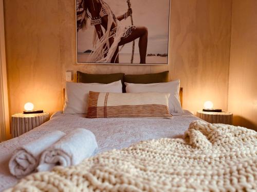 a bedroom with a bed with a blanket on it at Vitamin Sea Beach House in Riverton