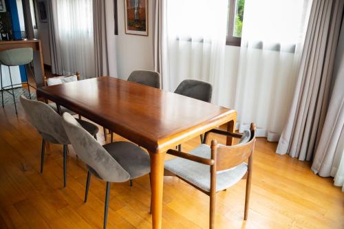 a dining room table with chairs and a wooden table at La Varangue in Antananarivo