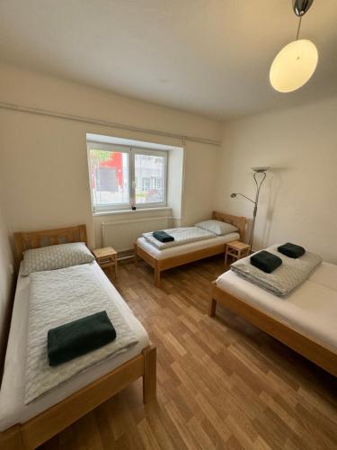 a room with two beds and a window at Mikulovská chalupa in Mikulov