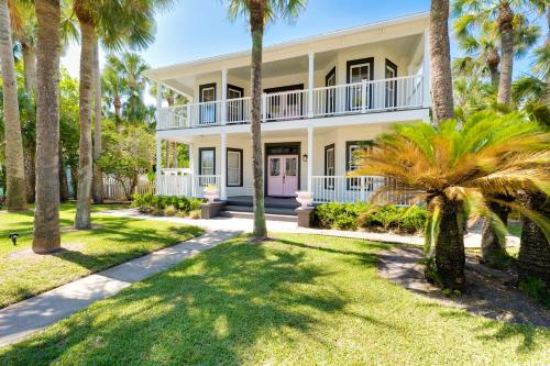 a house with palm trees in front of it at Be A Nomad - Pool - 1bdr Just 1 Block to the Beach in Jacksonville Beach