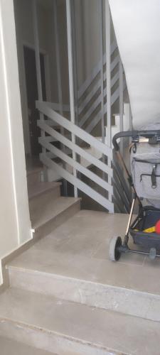 a cart parked next to a white stair railing at home_nafplio in Nafplio