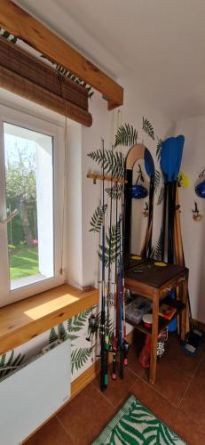 a room with skis on the wall and a window at Dom nad rzeką Legą in Sypitki