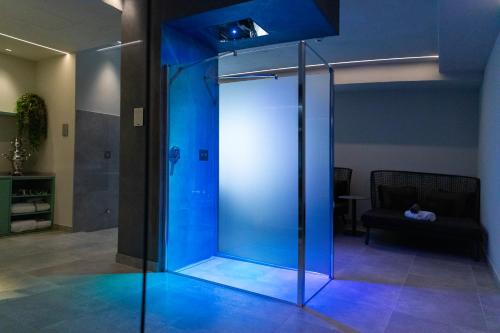 a glass shower with blue lighting in a room at Palace Hotel San Pietro in Bardolino