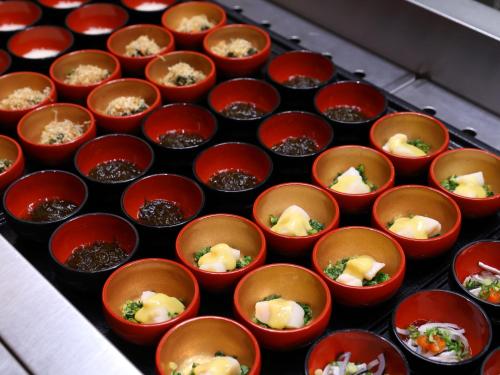 a tray of cups filled with food on a table at Dormy Inn Gifu Ekimae in Gifu