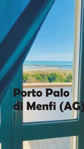 a sign on the door of a room with a view of the ocean at La Bussola in Porto Palo