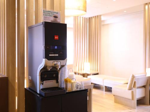 a machine on a stand in a living room at Dormy Inn Gifu Ekimae in Gifu