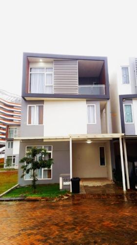 a white building with a tree in front of it at Montage Villa near Beach with Golf View in Nongsa