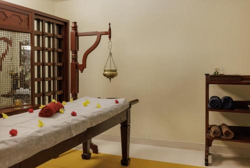 a room with a table with flowers on it at Gokulam Grand Turtle On The Beach in Kovalam