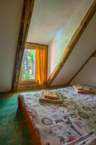 a bedroom with a bed and a window at Maple village in Žabljak