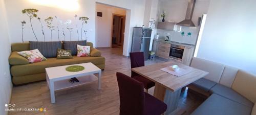 a living room with a couch and a table at Apartments Sofija in Vrsi