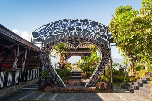 a gate to a hotel with a heart shaped entrance at Hiker's Camp at Toya Devasya in Kintamani
