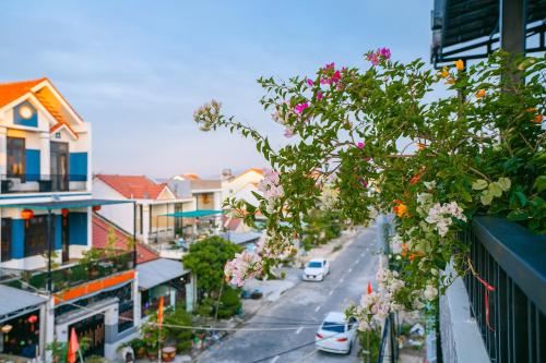 a view of a city street with flowers at Beach Palm Villa Hoi An in Hoi An