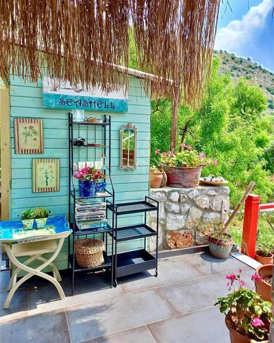 a blue house with a table and some plants at Valentina Boutique Hotel in Bozburun