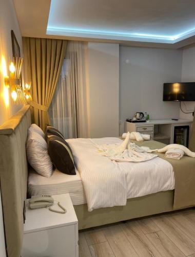 a hotel room with a large bed with towels on it at Mes Hotel & Spa in Samsun