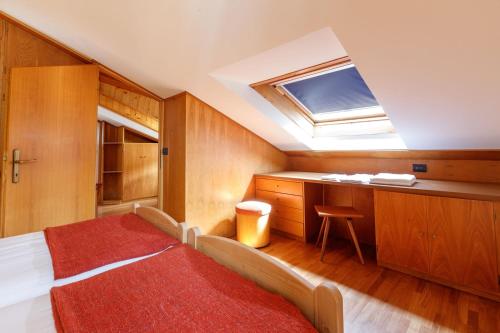 a bedroom with a bed and a skylight at Chalet Silvi Residence in Bormio
