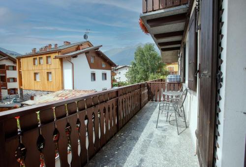a balcony with a chair and a view of a building at Chalet Silvi Residence in Bormio