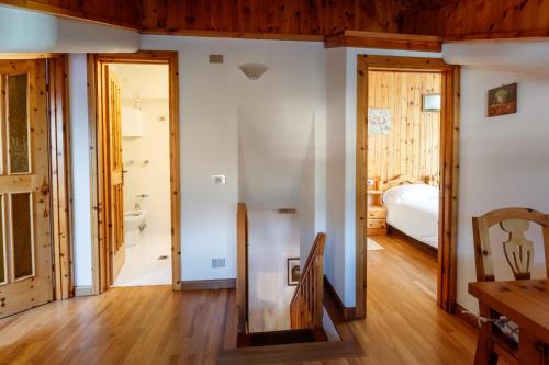 a room with a bedroom and a bed and a bathroom at Chalet Silvi Residence in Bormio