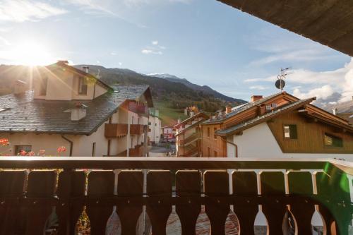 a view from a balcony of a town with houses at Chalet Silvi Residence in Bormio