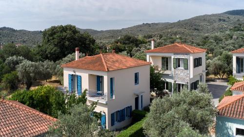 a view of a house with red tile roofs at Art Lesvos Villa 3 in Pyrgi Thermis
