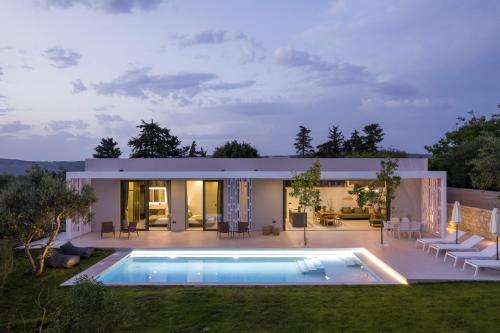 a house with a swimming pool in front of it at VILLA PETRA PHILIPPOS heated pool optional in Khámbatha