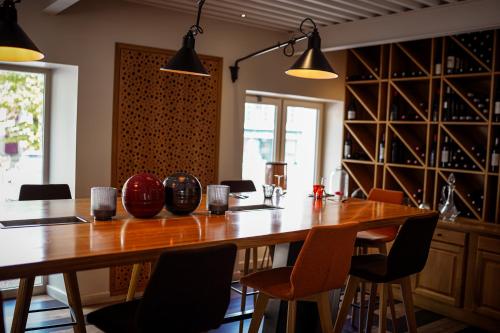 a dining room with a large wooden table and chairs at Logis Hostellerie de l'Abbaye in Celles-sur-Belle