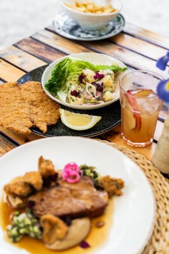 a table with two plates of food and a plate of food at Kővirág Panzió in Köveskál
