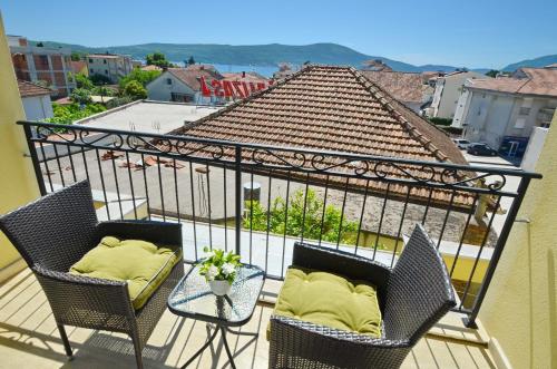 a balcony with two chairs and a table at Discovery Point Apartments in Tivat