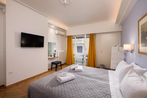 a bedroom with a bed with towels on it at Philos at Nikis - Two Bedroom in Plaka in Athens