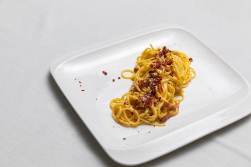 a plate of pasta on a white plate at Palace Hotel San Pietro in Bardolino
