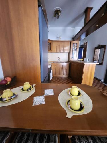 a dining room table with two yellow ducks on it at Maria's House in Alexandroupoli