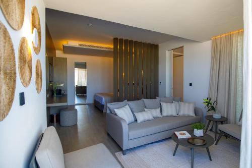 a living room with a couch and a table at Tasia Maris Beach Hotel - Adults Only in Ayia Napa