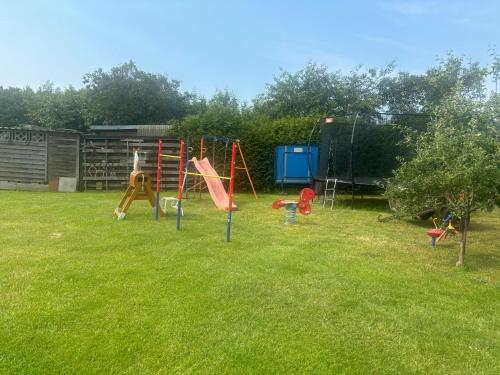 a yard with a playground in the grass at Karlchens Finnhütte in Papendorf