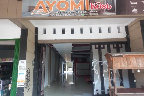 an empty hallway of a building with a sign on it at Hotel O Guest House Ayomi Syariah in Tegal
