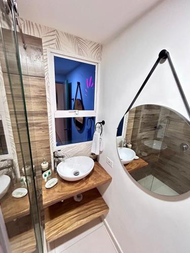 a bathroom with two sinks and a mirror at Hotel Sol Caribe Cartagena in Cartagena de Indias
