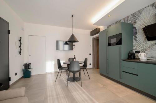 a kitchen and dining room with a table and chairs at ApartmentsGarda - Residenza Garda Deluxe in Garda
