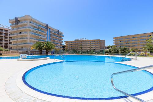 a large swimming pool in the middle of a city at UHC Larimar Family Complex in Salou
