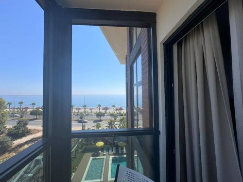 a room with a window looking out at the ocean at Ulu Panorama Residence in Alanya