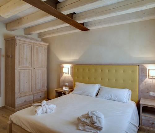 a bedroom with a white bed with two towels on it at Agriturismo Costa di Faraggiana in Levanto