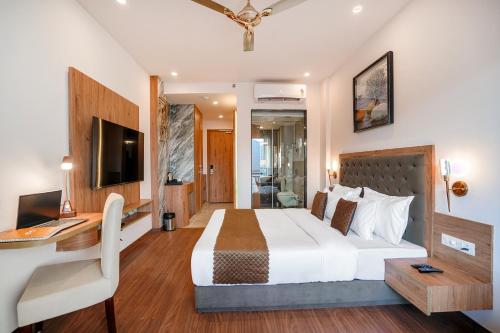 a bedroom with a bed and a desk and a computer at The Sanawar Heights I Kasauli I New Property in Kasauli