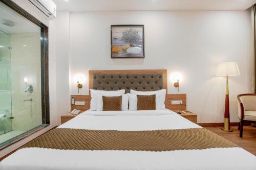 a bedroom with a large bed and a glass shower at The Sanawar Heights I Kasauli I New Property in Kasauli