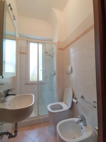 a bathroom with a toilet and a sink and a shower at Cipro Home in Rome