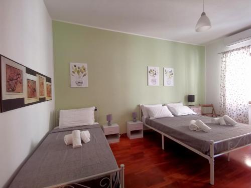a bedroom with two beds with towels on them at Cipro Home in Rome