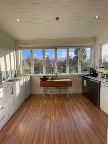 a large kitchen with a table in the middle of it at Auckland City Villa in Auckland