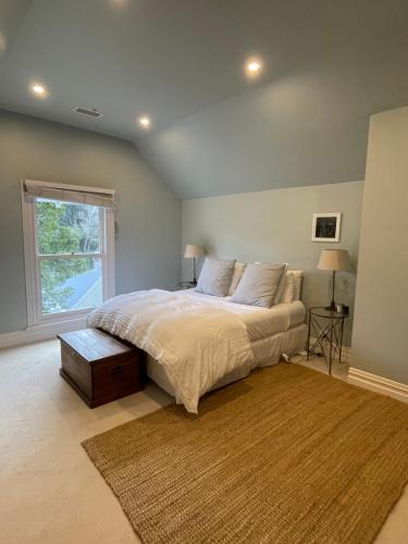 a bedroom with a large bed and a window at Auckland City Villa in Auckland