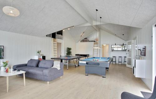 a living room with a couch and a pool table at Gorgeous Home In Bogense With Sauna in Bogense