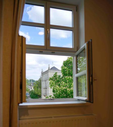 an open window with a view of a building at Lady Milavie apartments in Coburg