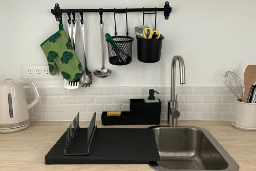 - un comptoir de cuisine avec évier et ustensiles dans l'établissement Au coeur du centre ville, à Dieppe